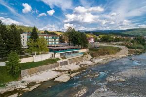 arial view of a river with a building in the background at Hotel Berane in Berane