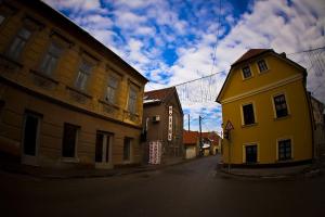 a yellow building on a street next to a building at Hostel Samobor in Samobor