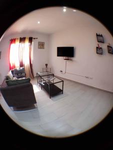 a living room with a couch and a tv at Villa Kate in Las Terrenas