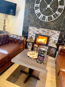 a living room with a couch and a fireplace at Bennetts Hotel in Long Eaton