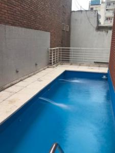 a large blue swimming pool on the side of a building at City Park Buenos Aires in Buenos Aires