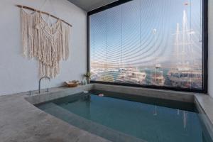 a bathroom with a swimming pool and a large window at Harbour Suites Fethiye in Fethiye