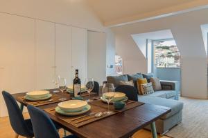 een eetkamer met een tafel en een bank bij LovelyStay - Lisbon Home With Castle View in Lissabon