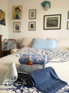 un letto con lenzuola e asciugamani blu e bianchi di Dimora Blu a Cisternino