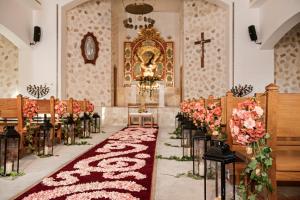 a row of pews in a church with flowers at Iberostar Paraíso Beach in Puerto Morelos