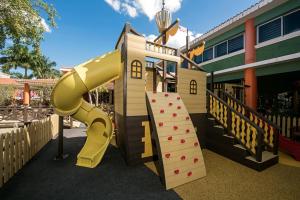 a playground with a slide in front of a building at Iberostar Paraíso Beach in Puerto Morelos
