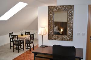 a dining room with a table and a mirror at Apartment ROCI in Šlapanice