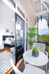 a room with a table and chairs and a bedroom at Designer Styled Studio in Central Trendy Glebe DUPLICATE in Sydney