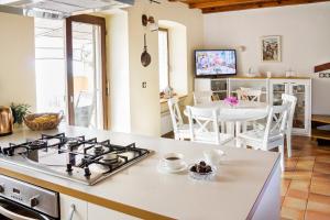 a kitchen and living room with a stove top oven at Holiday Home Amazing View in Piran