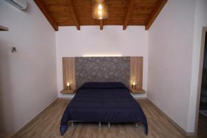 Кровать или кровати в номере Agriturismo al Riparo dai Venti