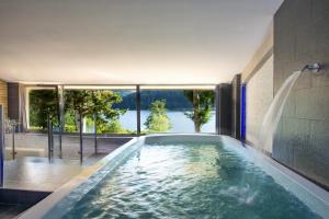a swimming pool with a waterfall in a house at Hotel Park 108 Sport&Wellness in Lorica
