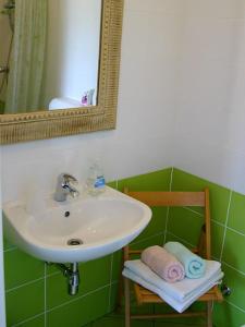 a bathroom with a sink and a mirror and a chair at Rooms Medved in Samobor