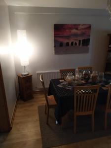 a dining room with a table and chairs and a lamp at Mountjoy House in Derry Londonderry