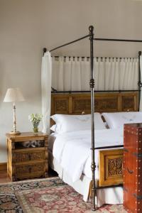 a bedroom with two beds and a canopy bed at Palacio Nazarenas, A Belmond Hotel, Cusco in Cusco