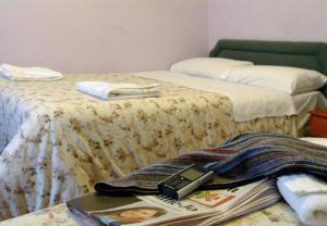 a bedroom with two beds with a table with a laptop at Holly House Hotel in London