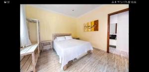 Ένα ή περισσότερα κρεβάτια σε δωμάτιο στο Magnólia