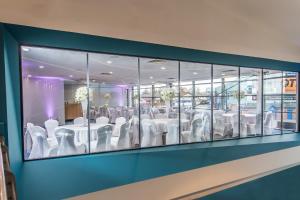 a conference room with white tables and chairs at The Park Hotel in Kilmarnock