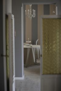 a dining room with a table and a chandelier at Cupido da Simona in Ostellato