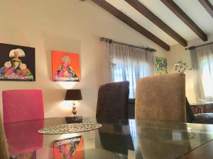 a dining room with a glass table and chairs at Villa Dorotea in El Rompido