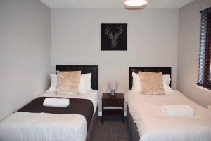 Postel nebo postele na pokoji v ubytování Kelpies Serviced Apartments Hamilton- 2 Bedrooms