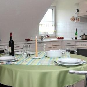 a kitchen with a table with a candle on it at Ferienwohnung-Wiesengrund in Petersdorf auf Fehmarn