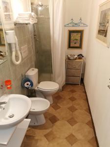 a bathroom with a toilet and a shower and a sink at Borgo Marinaro in Aci Castello