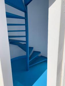 a staircase with blue risers in a room at Puerto del Carmen Luxury Apartment in Tías