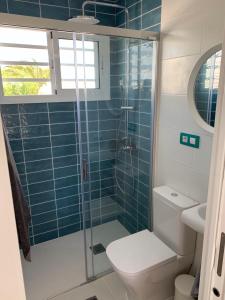 a bathroom with a toilet and a glass shower at Puerto del Carmen Luxury Apartment in Tías