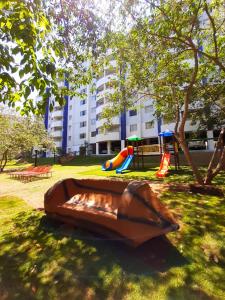 a wooden boat in a park with a playground at Prime Hotel Águas da Serra in Rio Quente