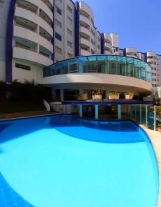 a large swimming pool in front of a building at Prime Hotel Águas da Serra in Rio Quente