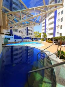 a large swimming pool in front of a building at Prime Hotel Águas da Serra in Rio Quente