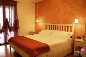 a bedroom with a large bed and a window at Prati di Maja B&B in Miglianico
