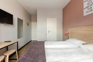 Ένα ή περισσότερα κρεβάτια σε δωμάτιο στο Nomera na Goncharnoy