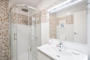 a white bathroom with a shower and a sink at La Entallada in Las Playas +16 photos