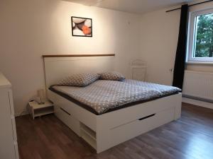 a bedroom with a bed with a white bed frame at Ferienwohnung Seibert inkl Chiemgaukarte in Bergen