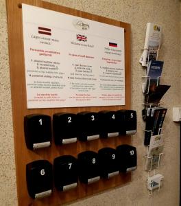a row of electrical devices on a wall with a sign at Hotel Pils with Self-Check in in Sigulda