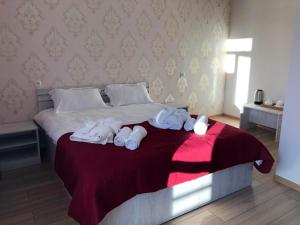 a bedroom with a bed with towels on it at Wander Kazbegi Hotel in Stepantsminda