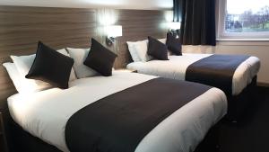 A bed or beds in a room at The Bruce Hotel 