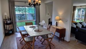 a dining room and living room with a table and chairs at Lisbon Coast Family Home in São Domingos de Rana