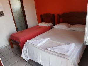 سرير أو أسرّة في غرفة في Pousada Belo Horizonte
