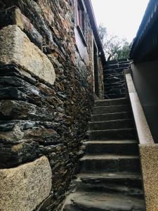 a stone stairway leading up to a brick building at "Casa do Avô Armindo" Mountain Experience in Vila Real