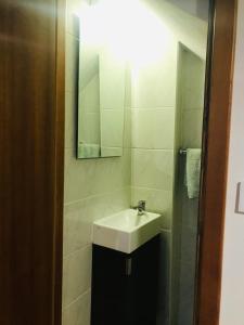 a bathroom with a sink and a mirror at "Casa do Avô Armindo" Mountain Experience in Vila Real