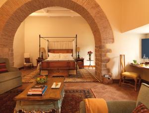 a living room with a bed and an archway at Palacio Nazarenas, A Belmond Hotel, Cusco in Cusco