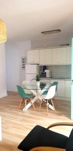 a kitchen with a table and chairs in a room at Casa Angy 3 in Zahora