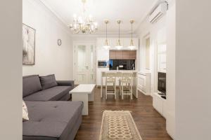 ein Wohnzimmer mit einem Sofa und einem Tisch in der Unterkunft Belgrade Center Apartment Slavija Square II in Belgrad