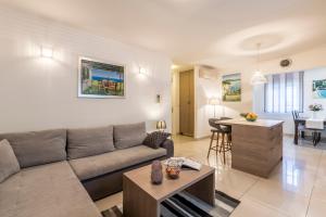 a living room with a couch and a table at Varoš apartment in Split