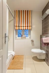 a bathroom with a tub and a toilet and a window at Varoš apartment in Split