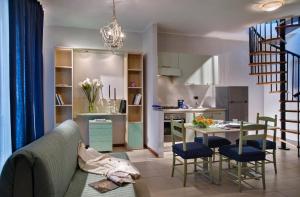 a living room and kitchen with a couch and a table at Residence Viale Venezia in Verona