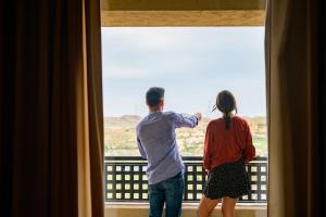 a man and a woman standing in front of a window at Valle Del Este Golf Resort in Vera