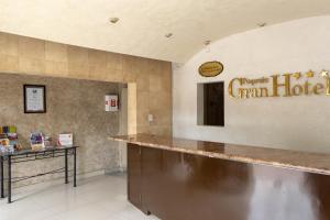 a bar in a restaurant with a sign that readsarma hotel at Pequeno Gran Hotel in Aguascalientes